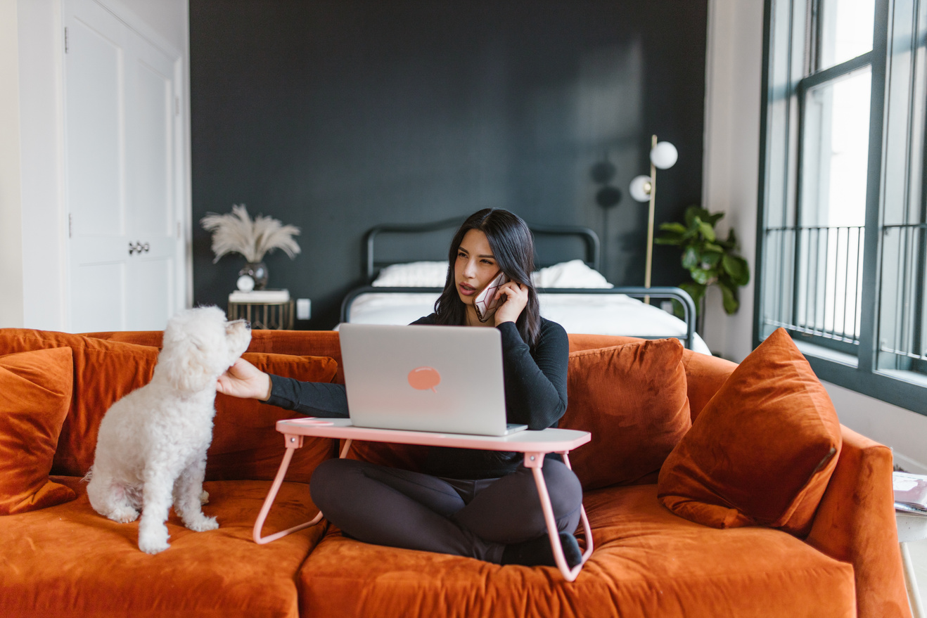 Woman Petting a Dog While on Phone Call